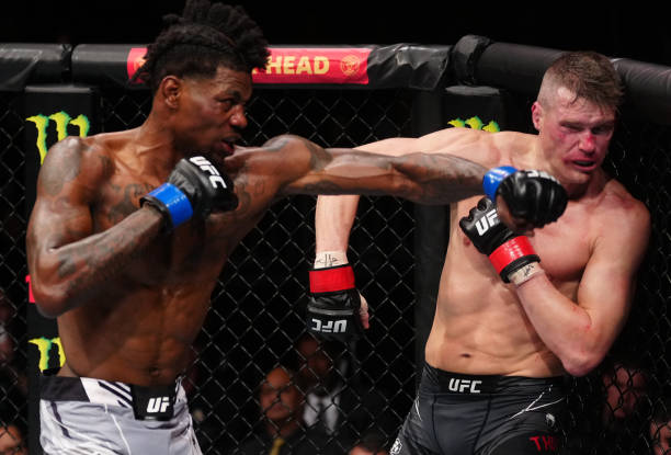 Kevin Holland punches Stephen Thompson in a welterweight fight during the UFC Fight Night event at Amway Center on December 03, 2022 in Orlando,...