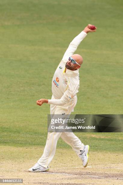 Nathan Lyon of Australia bowls his off spin during day five of the First Test match between Australia and the West Indies at Optus Stadium on...