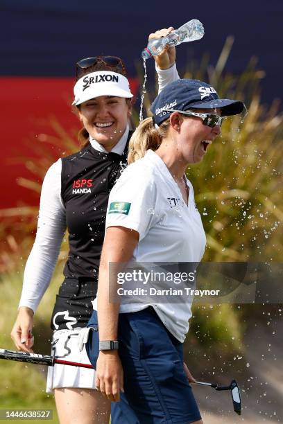 Hannah Green pours water over the head of winner Ashleigh Buhai on the 18th hole during Day 4 of the 2022 ISPS HANDA Australian Open at Victoria Golf...