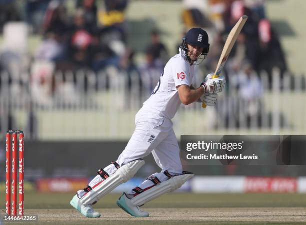 Joe Root of England hits the ball towards the boundary during the First Test Match between Pakistan and England at Rawalpindi Cricket Stadium on...