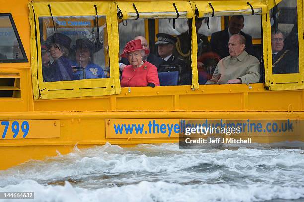 Queen Elizabeth II and Prince Philip, Duke of Edinburgh take a ride on the Yellow Duck and amphibious vehicle during a visit to Merseyside Maritime...