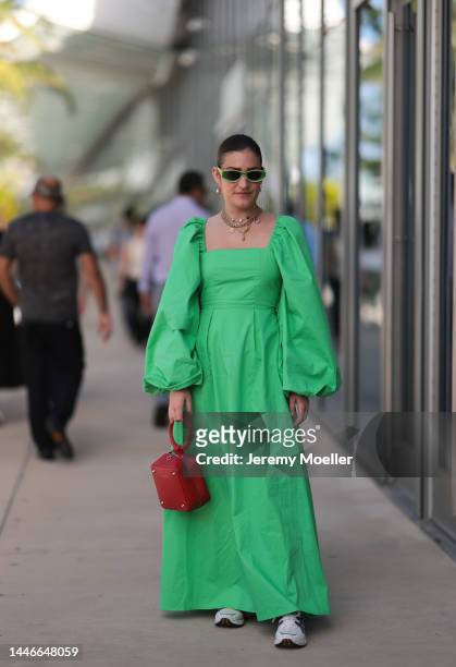 Eugenia Durandy seen wearing a green long dress with wide puffed sleeves, Loewe shades and a red bag by Sequoia on December 02, 2022 in Miami,...
