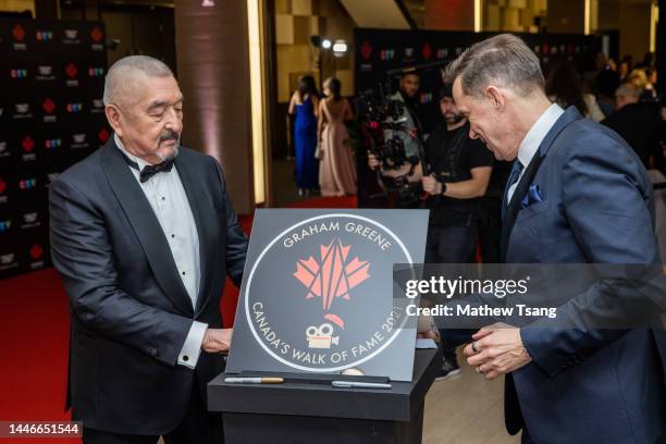 Graham Greene and Jeffrey Latimer attend the unveiling of Graham's Canada’s Walk of Fame 2021 commemorative plaque for Arts & Entertainment during...