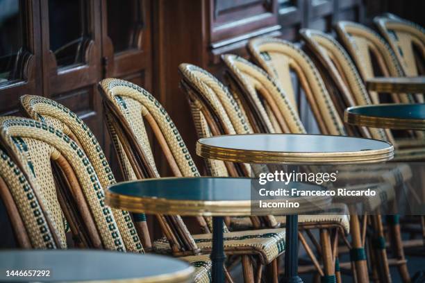 typical french chairs of cafe in paris - paris france cafe stock pictures, royalty-free photos & images