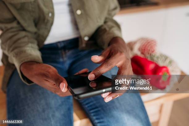 woman scrolling smart phone at home - scroll stock pictures, royalty-free photos & images