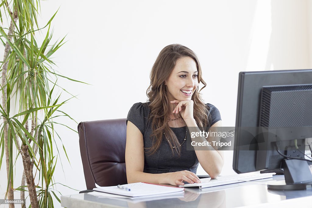 Smiling businesswoman working in an office