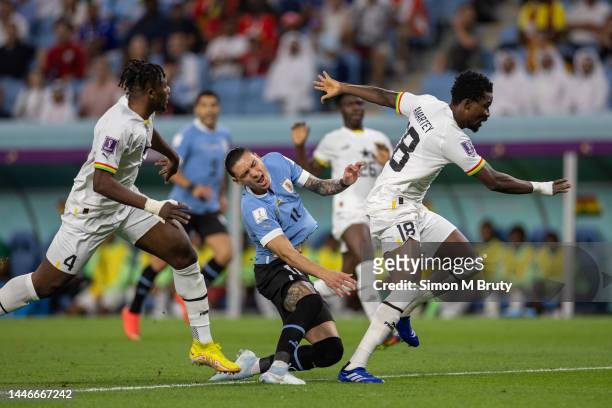 Darwin Nunez of Uruguay is challenged by Daniel Amartey of Ghana during the FIFA World Cup Qatar 2022 Group H match between Ghana and Uruguay at Al...