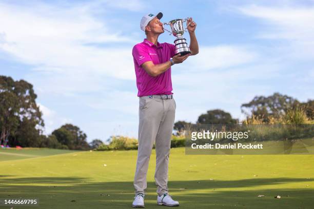 Adrian Meronk of Poland holds the trophy after winning the 2022 ISPS HANDA Australian Open at Victoria Golf Club on December 04, 2022 in Melbourne,...
