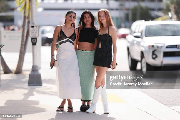 Guests seen wearing a lingerie dress with sandals, a crop top with a green printed skirt and a mini skirt with white cowboy boots on December 02,...