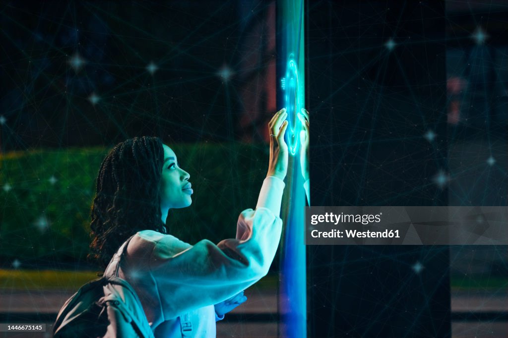 Young woman experimenting immersive experience at night
