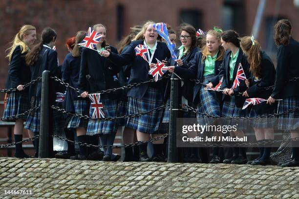 Well-wishers await the arrival of Queen Elizabeth II during a visit to Merseyside Maritime Museum on May 17, 2012 in Liverpool, England. The Queen is...