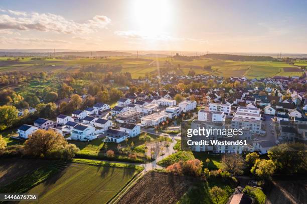 germany, baden-wurttemberg, waiblingen, aerial view of modern energy efficient suburb at autumn sunset - baden baden aerial fotografías e imágenes de stock