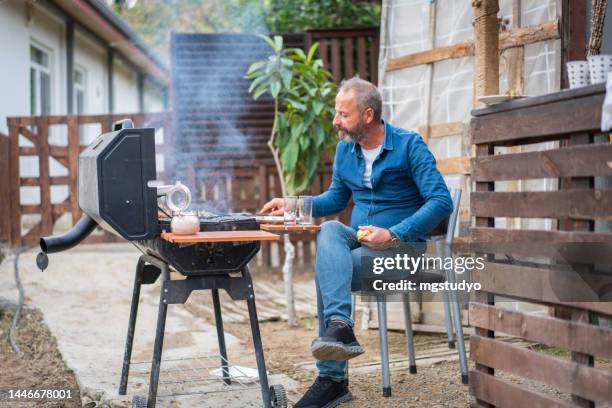 Man Using Grill 1,604 Man Grilling Backyard Stock Photos, High-Res Pictures, and Images ...