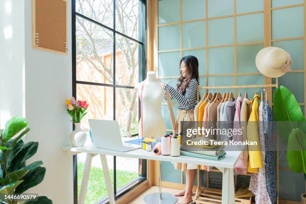 young asian fashion designer woman working in a fashion atelier. - designer shopping stock pictures, royalty-free photos & images
