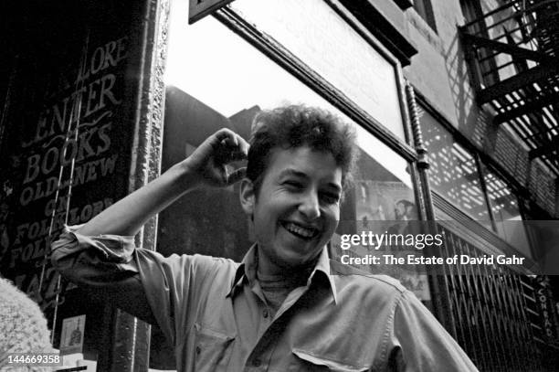 Singer songwriter Bob Dylan poses for a portrait in May 1962 in front of the Folklore Center, the legendary folk music store on MacDougal Street in...