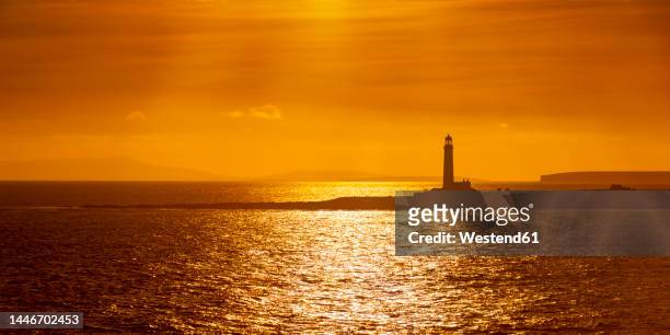 uk, scotland, sanday, panoramic view of start point lighthouse at moody dusk - orkney stock pictures, royalty-free photos & images