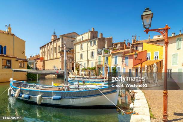 france, provence-alpes-cote dazur, martigues, boats moored along town canal - martigues stock pictures, royalty-free photos & images