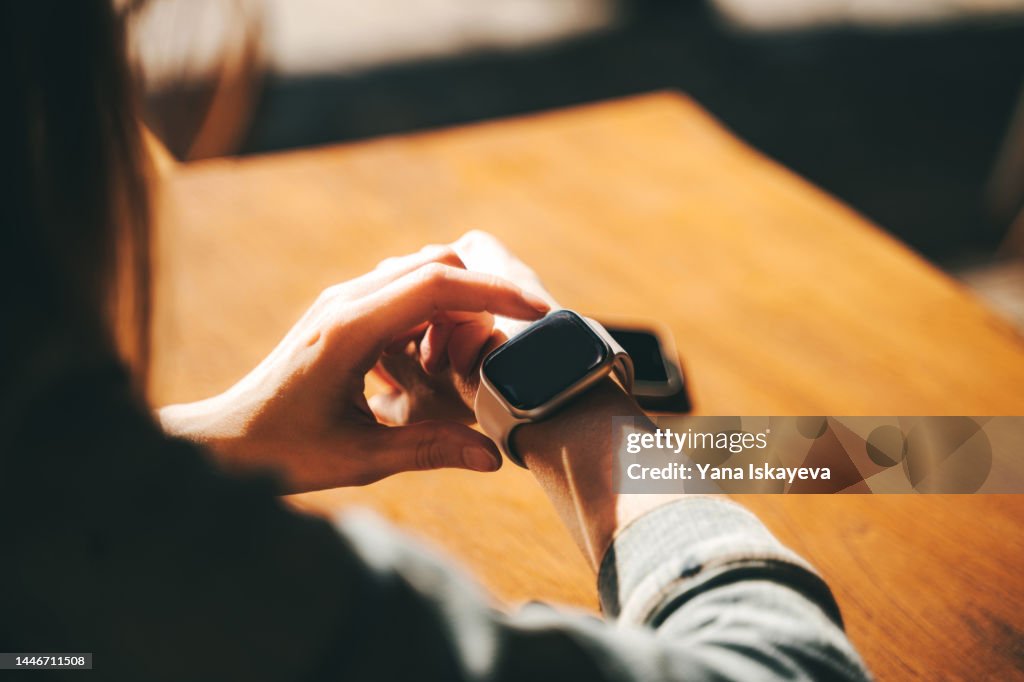 Modern woman using smart watch for daily tasks
