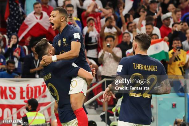 Olivier Giroud of France celebrates with team mate Kylian Mbappe on becoming the all-time leading goalscorer for the France National team after...