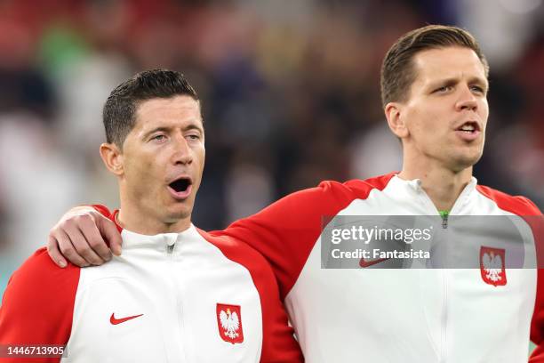 Robert Lewandowski and Wojciech Szczesny of Poland sing during the line up for the National anthems prior to kick off in the FIFA World Cup Qatar...