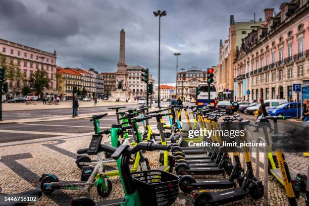 electric push scooter rental location in lisbon - sharing economy stockfoto's en -beelden