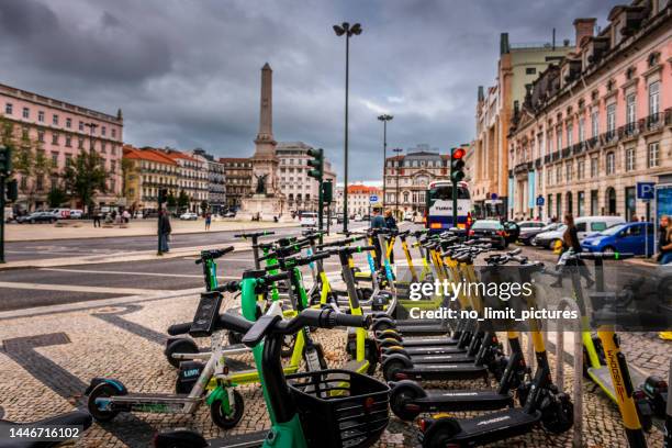 electric push scooter rental location in lisbon - sharing economy stock pictures, royalty-free photos & images