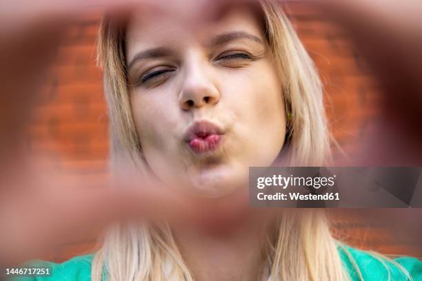 beautiful young woman puckering lips - puckering stock pictures, royalty-free photos & images