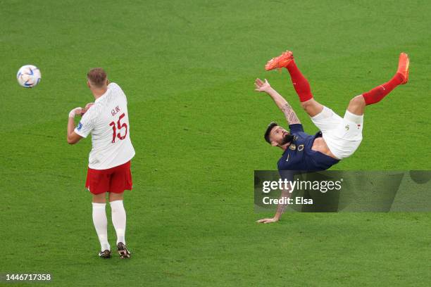 Olivier Giroud of France attempts an overhead kick while under pressure from Kamil Glik of Poland during the FIFA World Cup Qatar 2022 Round of 16...