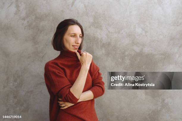 girl in warm red sweater - ladies day stock pictures, royalty-free photos & images