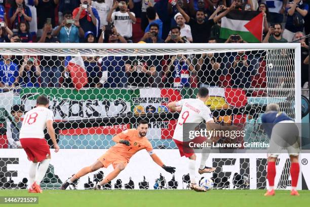 Robert Lewandowski of Poland scores the team's first goal off a penalty against Hugo Lloris of France during the FIFA World Cup Qatar 2022 Round of...