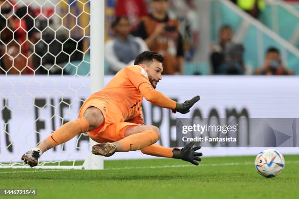 Hugo Lloris of France saves a penalty from Robert Lewandowski of Poland prior to it being retaken due to the goalkeeper leaving his goal line during...