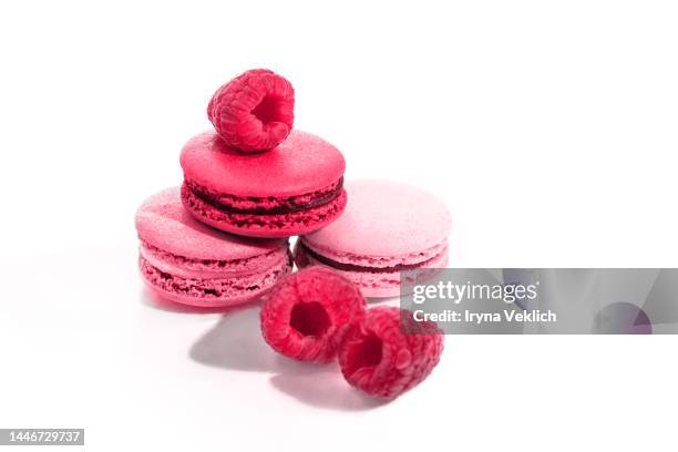 tasty french macaroons or macarons, macaruns in color of the year 2023 viva magenta and raspberries. - cupcake box stock pictures, royalty-free photos & images