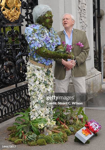 Sir David Attenborough poses with a floral sculpture of himself outside the Royal Botanical Gardens at Kew Gardens on May 17, 2012 in London,...