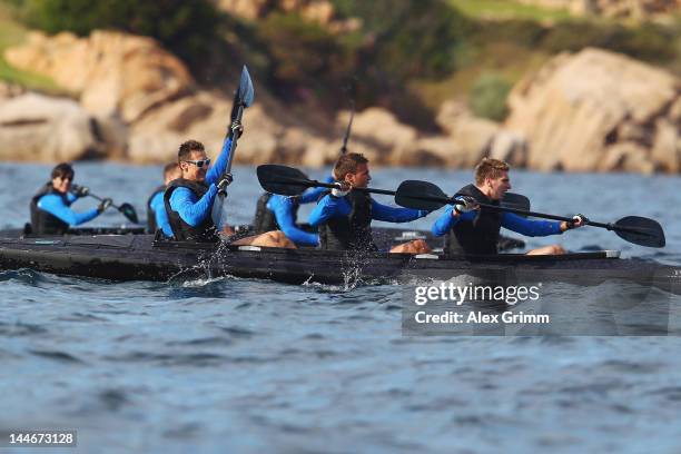 Head coach Joachim Loew watches Ron-Robert Zieler, Mario Goetze and Miroslav Klose compete during a boat race of the German national football team...