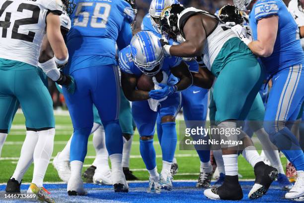 Jamaal Williams of the Detroit Lions rushes for a touchdown against the Jacksonville Jaguars during the first quarter of the game at Ford Field on...