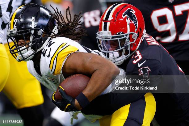 Najee Harris of the Pittsburgh Steelers is tackled by Mykal Walker of the Atlanta Falcons during the first quarter of the game at Mercedes-Benz...