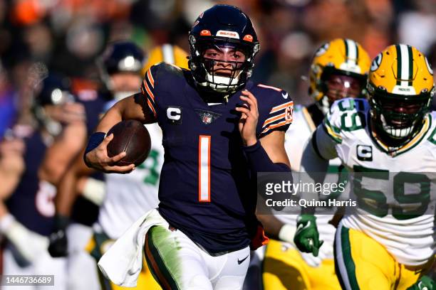 Justin Fields of the Chicago Bears rushes for a touchdown during the first quarter of the game against the Green Bay Packers at Soldier Field on...