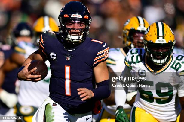 Justin Fields of the Chicago Bears rushes for a touchdown during the first quarter of the game against the Green Bay Packers at Soldier Field on...