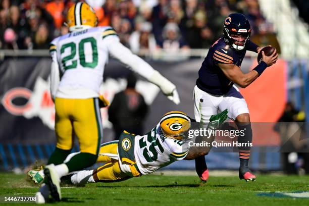 Justin Fields of the Chicago Bears breaks the tackle by Keisean Nixon of the Green Bay Packers in a rush for a touchdown during the first quarter of...