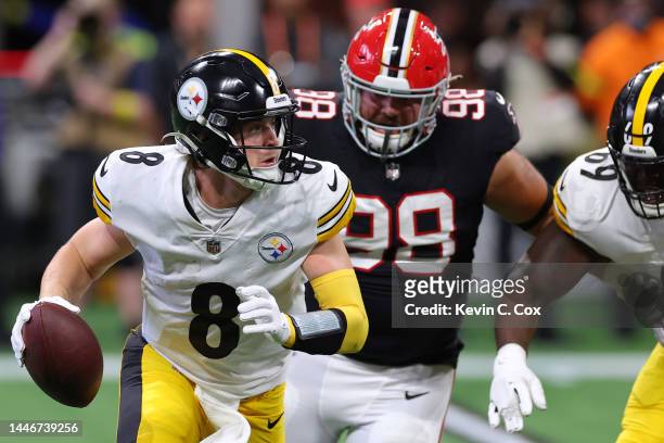 Kenny Pickett of the Pittsburgh Steelers is pressured out of the pocket during the first quarter of the game against the Atlanta Falcons at...