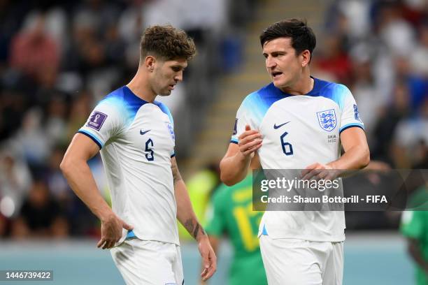 John Stones and Harry Maguire of England speak during the FIFA World Cup Qatar 2022 Round of 16 match between England and Senegal at Al Bayt Stadium...