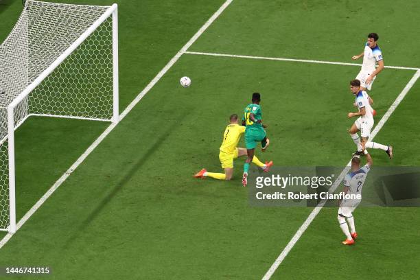 Ismaila Sarr of Senegal shoots past Jordan Pickford of England during the FIFA World Cup Qatar 2022 Round of 16 match between England and Senegal at...