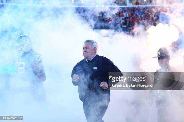 Head coach Mack Brown of the North Carolina Tar Heels runs onto the field for the ACC Championship game against the Clemson Tigers at Bank of America...