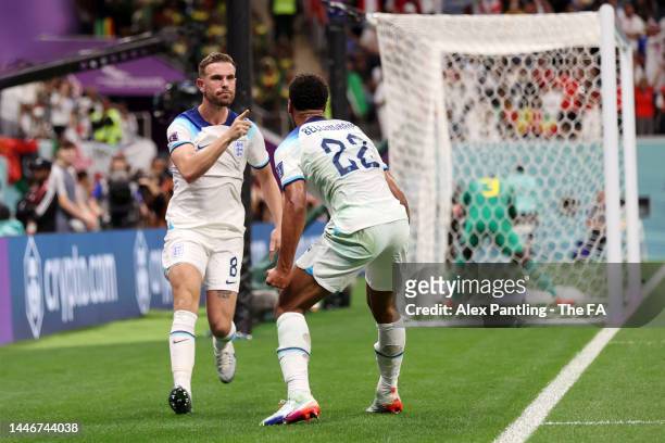 Jordan Henderson of England celebrates with teammate Jude Bellingham after scoring the team's first goal during the FIFA World Cup Qatar 2022 Round...