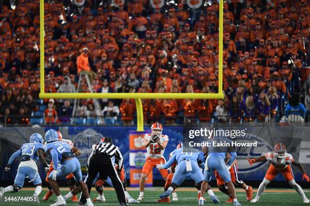 Hunter Johnson of the Clemson Tigers catches a snap against the North Carolina Tar Heels in the fourth quarter during the ACC Championship game at...