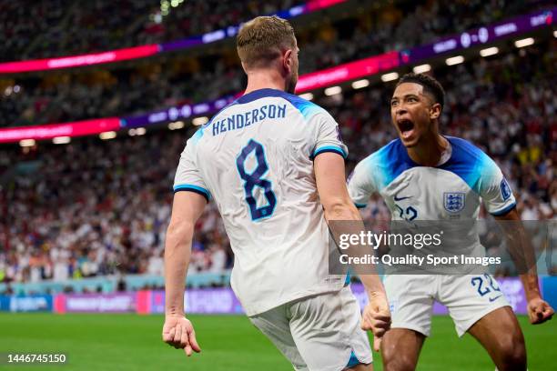 Jordan Henderson of England celebrates with Jude Bellingham after scoring his team's first goal during the FIFA World Cup Qatar 2022 Round of 16...