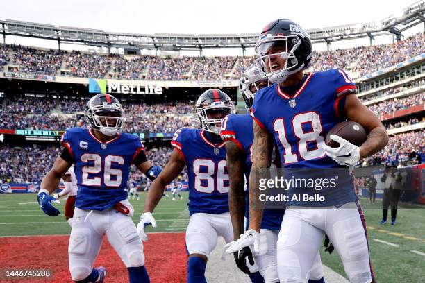 Isaiah Hodgins of the New York Giants celebrates after scoring a touchdown in the third quarter of a game against the Washington Commanders at...
