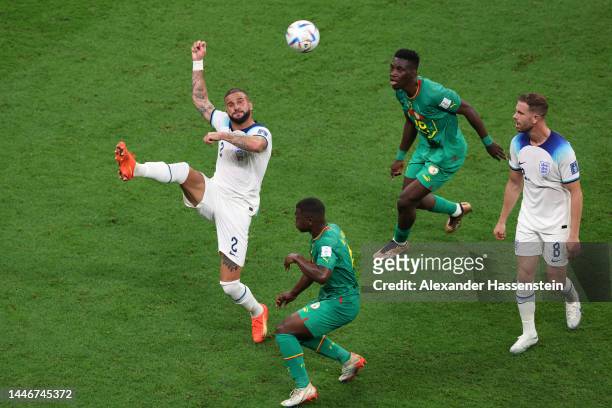 Kyle Walker of England controls the ball against Nampalys Mendy of Senegal during the FIFA World Cup Qatar 2022 Round of 16 match between England and...