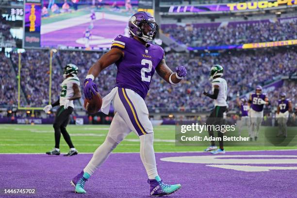 Alexander Mattison of the Minnesota Vikings celebrates after scoring a touchdown during the second quarter against the New York Jets at U.S. Bank...