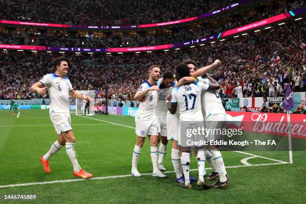 Harry Kane of England celebrates with teammates after scoring the team's second goal during the FIFA World Cup Qatar 2022 Round of 16 match between...